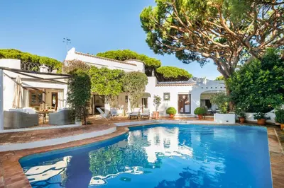 a house with a swimming pool in front of a house at Charming Vale Do Lobo Retreat 3 Bedrooms Private Pool & Close To Amenities in Almancil