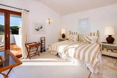 a bridge over a body of water with people on it at Charming Vale Do Lobo Retreat 3 Bedrooms Private Pool & Close To Amenities in Almancil