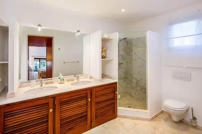 a white bedroom with a bed and a balcony at Charming Vale Do Lobo Retreat 3 Bedrooms Private Pool & Close To Amenities in Almancil