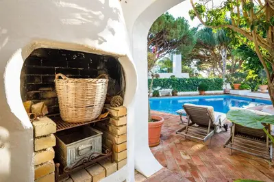 a patio with a table and chairs and plants at Charming Vale Do Lobo Retreat 3 Bedrooms Private Pool & Close To Amenities in Almancil
