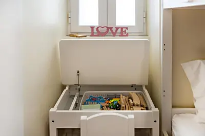 a drawer filled with toys in front of a window at Blue Peacock in Faro