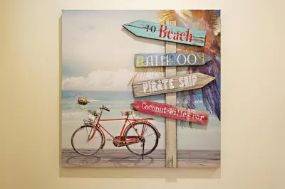 a picture of a sign with a bike on the beach at Blue Peacock in Faro