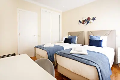 two beds in a room with blue and white at Blue Peacock in Faro