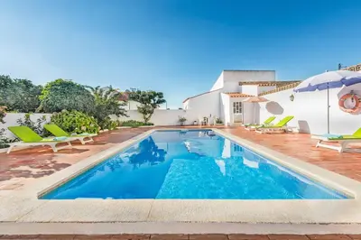 a swimming pool in front of a house at Villa Bento Dios in Galé