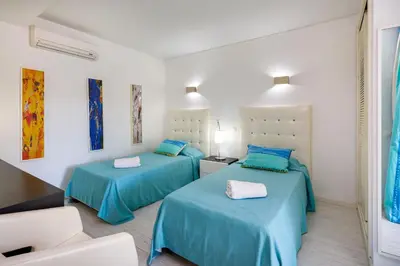 two beds in a room with blue sheets at Charming Vale Do Lobo Villa 4 Bedrooms Villa Quadradinhos 22 Private Pool in Almancil