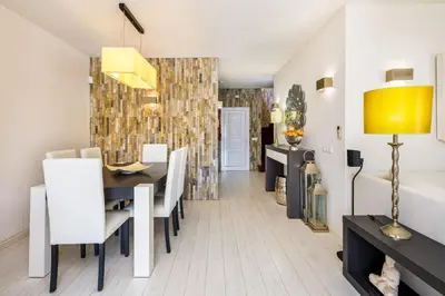 a dining room and living room with a table and chairs at Charming Vale Do Lobo Villa 4 Bedrooms Villa Quadradinhos 22 Private Pool in Almancil