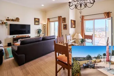 a living room with a couch and a tv at NEU - Casa Tina mit Meerblick und Pool in Guia