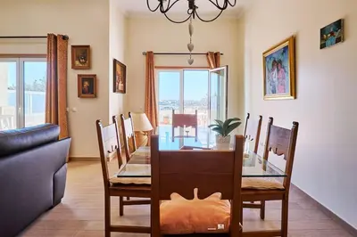 a dining room with a glass table and chairs at NEU - Casa Tina mit Meerblick und Pool in Guia