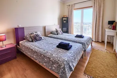 a bedroom with two beds and a window at NEU - Casa Tina mit Meerblick und Pool in Guia