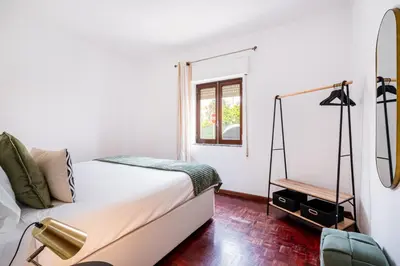 a white bedroom with a bed and a mirror at Mar&Mar Old Town 2 Bedroom Apartment in Albufeira