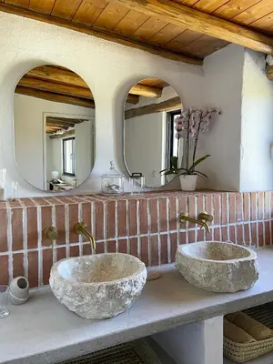 two sinks in a bathroom with two mirrors at Casa Estrela in Loulé