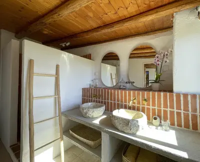 a bathroom with two sinks and a mirror at Casa Estrela in Loulé