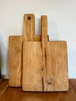 two wooden cutting boards sitting on top of a table at Casa Estrela in Loulé
