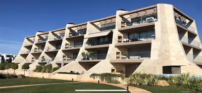 a large building with a lot of windows at Two Bedroom Laguna Village - By Vilamoura Sun in Quarteira
