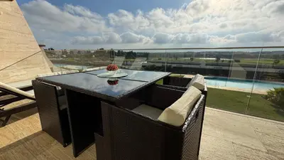 a table and chairs on a balcony with a view at Two Bedroom Laguna Village - By Vilamoura Sun in Quarteira