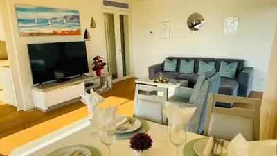 a living room with a couch and a table at Two Bedroom Laguna Village - By Vilamoura Sun in Quarteira