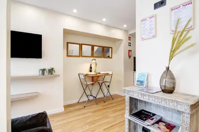 a living room with a fireplace and a tv at Bougainvillea House in Faro