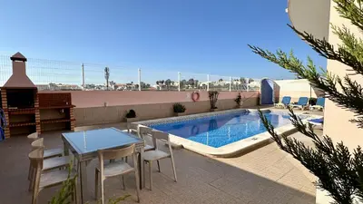 a patio with a table and chairs next to a swimming pool at Antonieta by Check-in Portugal in Albufeira
