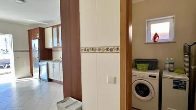 a kitchen with a washer and a washing machine at Antonieta by Check-in Portugal in Albufeira