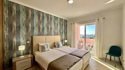 a bedroom with a bed and a large window at Antonieta by Check-in Portugal in Albufeira