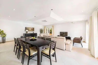 a kitchen with white cabinets and stainless steel appliances at Villa Cabrita de Parra in Galé