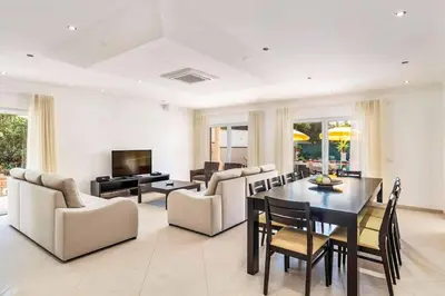 a living room with a table and chairs and a television at Villa Cabrita de Parra in Galé