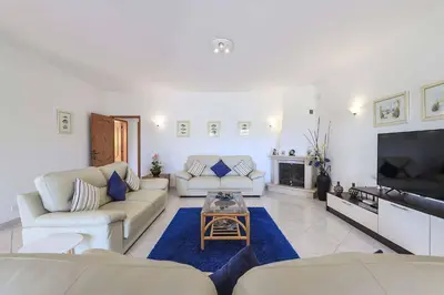 a living room with two couches and a tv at Villa Mica in Azinhal