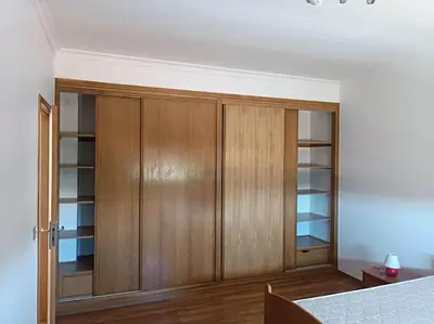 a bedroom with wooden cabinets and a bed at Holiday HouseV5 W/Pool & BBQ in Albufeira
