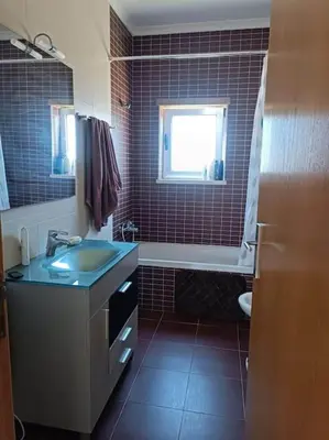 a bathroom with a sink and a tub and a window at Holiday HouseV5 W/Pool & BBQ in Albufeira