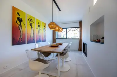 a dining room with a wooden table and chairs at Casa Esmarand in Albufeira