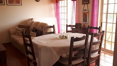 a dining room with a table and a couch at Marina Vila Apartment with Pool in Albufeira