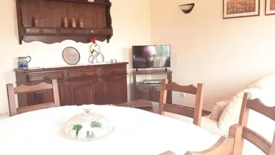 a living room with a table and a tv at Marina Vila Apartment with Pool in Albufeira