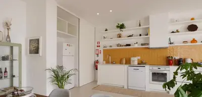 a kitchen with white cabinets and white appliances at Casa Longa Faro - Traditional Portuguese House with modern comforts in Faro