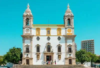 a large white building with a clock tower at Casa Longa Faro - Traditional Portuguese House with modern comforts in Faro