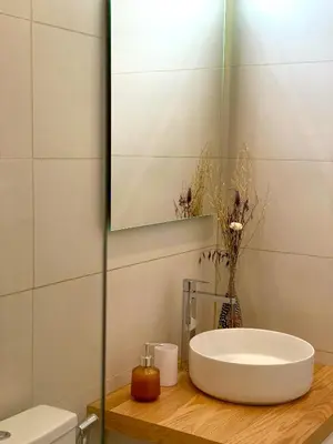 a bathroom with a white sink and a mirror at Casa Longa Faro - Traditional Portuguese House with modern comforts in Faro