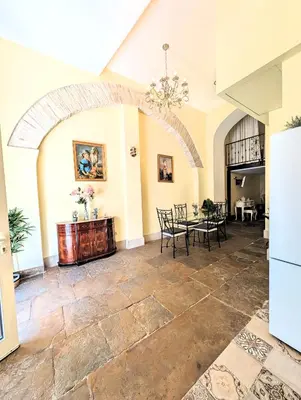 a large living room with a table and chairs at Grand studio 29 in Faro