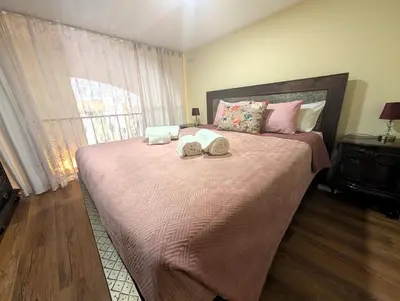 a bedroom with a large bed with two towels on it at Grand studio 29 in Faro