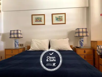 a room with a bed with a sign on it at Discovery Apartment Vilamoura in Vilamoura