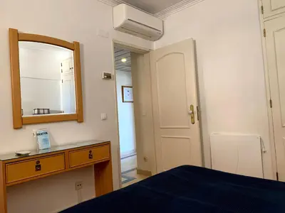 a bedroom with a bed and a mirror and a dresser at Discovery Apartment Vilamoura in Vilamoura