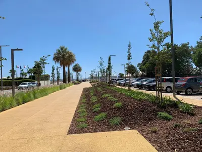 a sidewalk next to a parking lot with cars at Discovery Apartment Vilamoura in Vilamoura