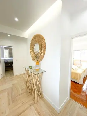 a room with a table with a mirror and a bed at Apartments Home Sweet Home in Faro