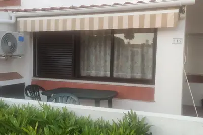 a green bench sitting outside of a house at Cadete house in Albufeira
