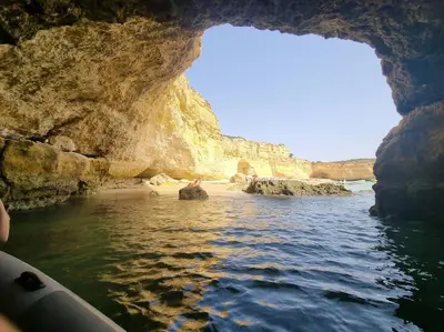 a view of a cave from a boat in the water at Cadete house in Albufeira