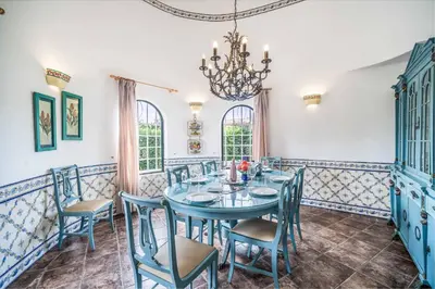 a dining room with a blue table and chairs at Villa Silveira in Vilamoura
