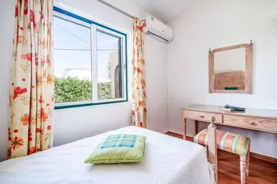 a bedroom with a bed and a window at Villa Silveira in Vilamoura