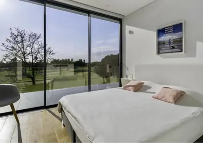 a bedroom with a bed and a large window at Villa Algarve Paradise in Vilamoura