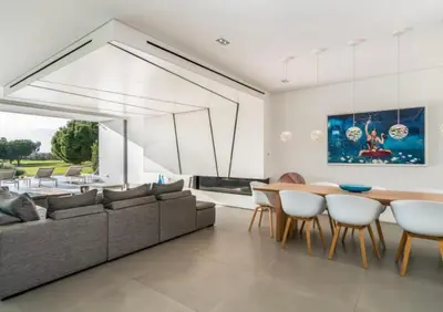 a living room with a couch and a table and chairs at Villa Algarve Paradise in Vilamoura