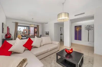 a living room with a couch and a table at Pine Garden Apartment Vilamoura in Vilamoura