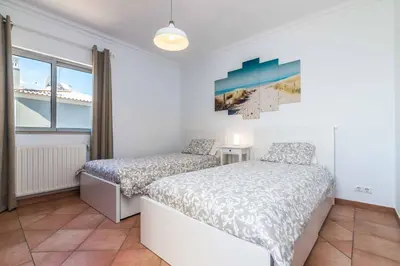 a bedroom with two beds and a window at Villa Katharina in Albufeira