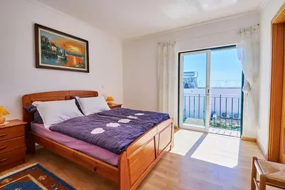 a bedroom with a bed and a large window at Casa Felix mit Pool in Albufeira